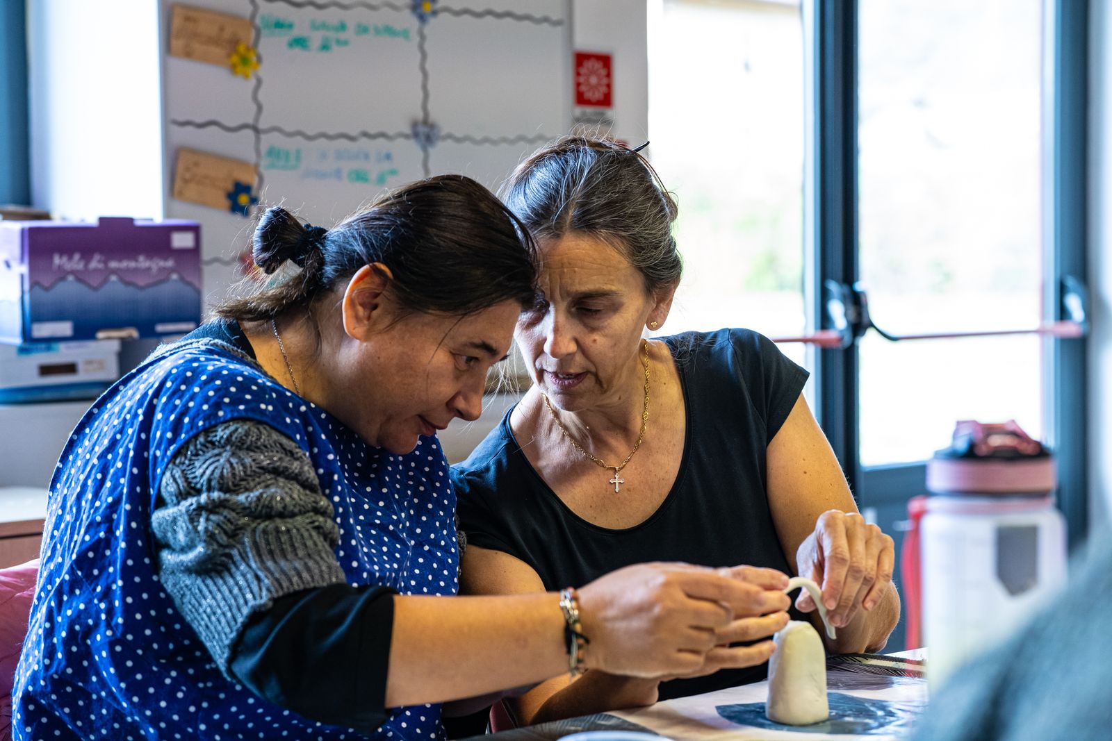 A support worker and a resident working together in a workshop